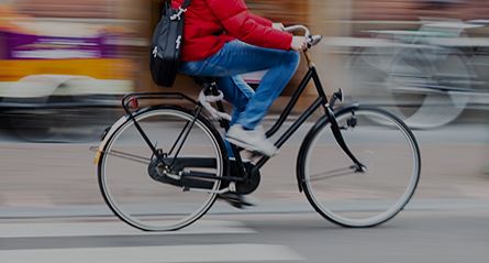 person riding a bicycle on a busy street